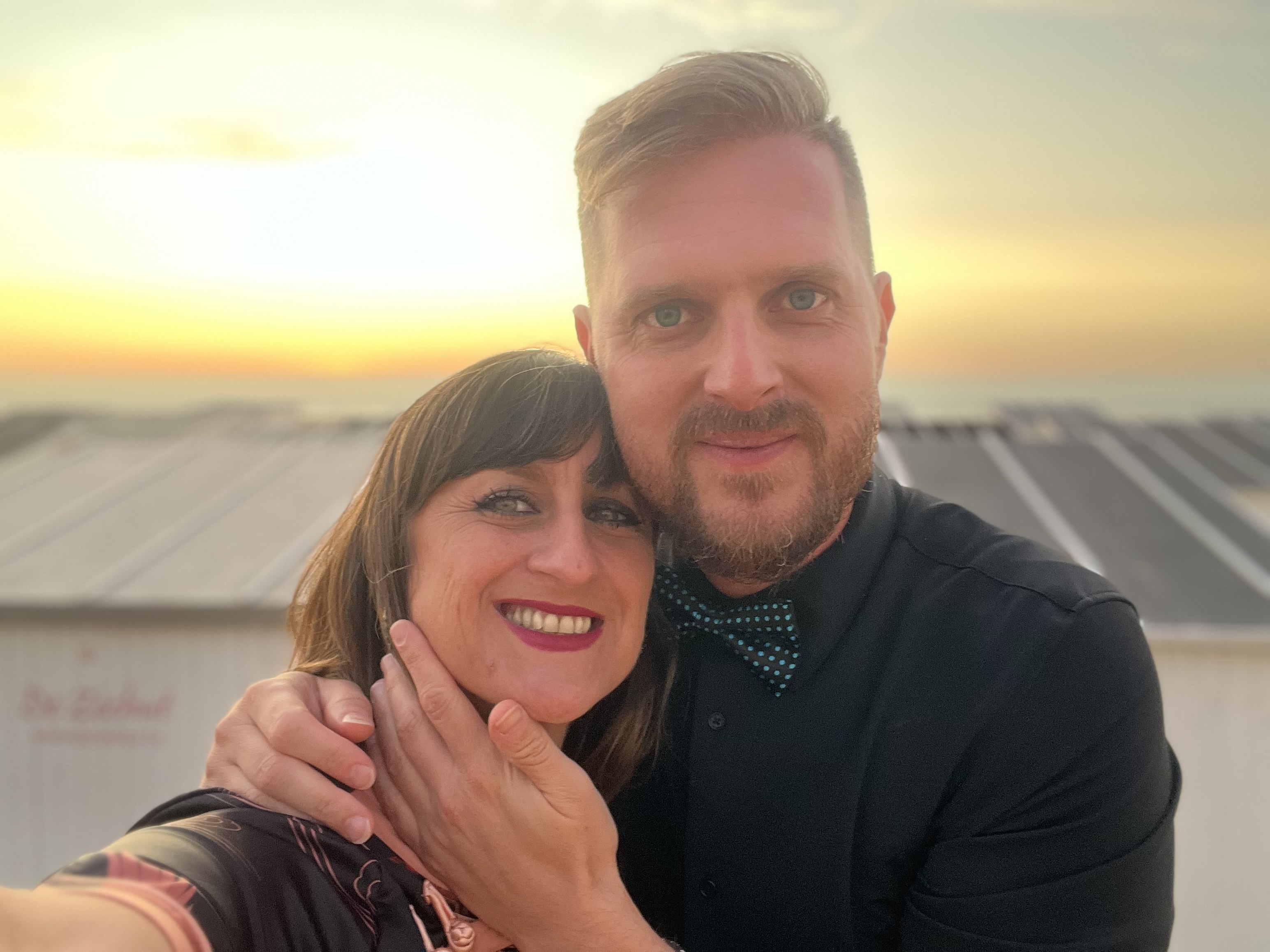 Stef and Laz together by the sea at sunset